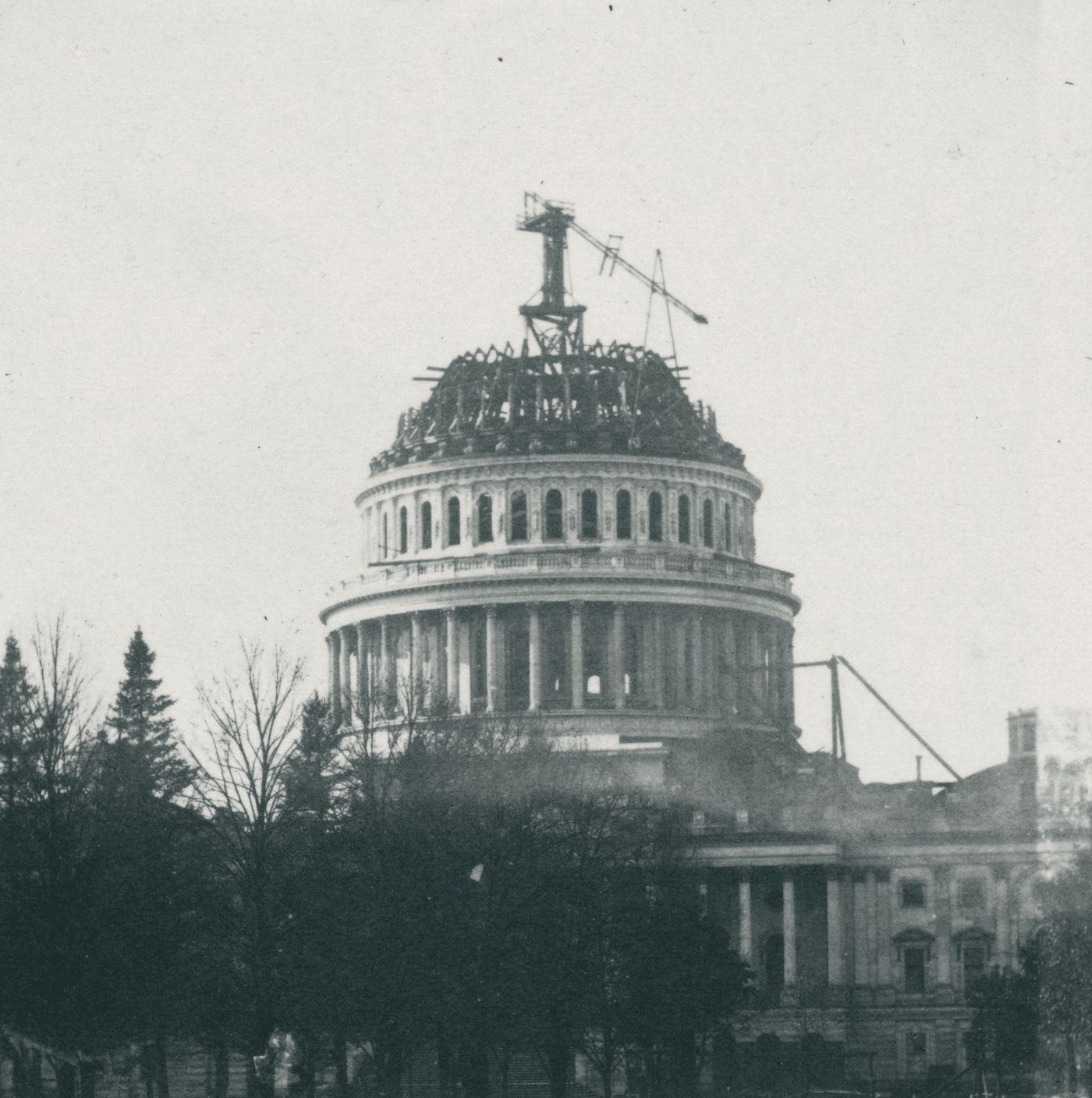 The U.S. Capitol with its new cast-iron dome under construction and a crane on top, early 1860s