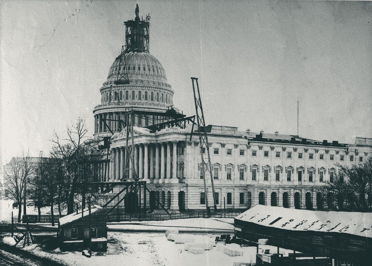 The U.S. Capitol in snow, with the Statue of Freedom atop the nearly finished dome inside its scaffolding